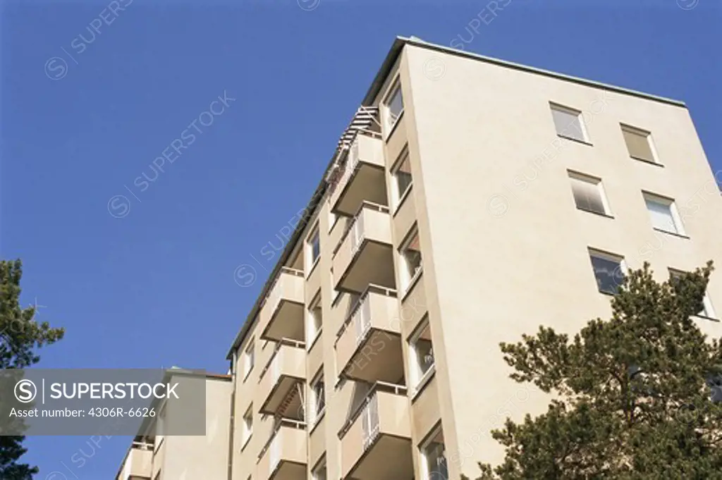 Low angle view of multi storey building against blue sky