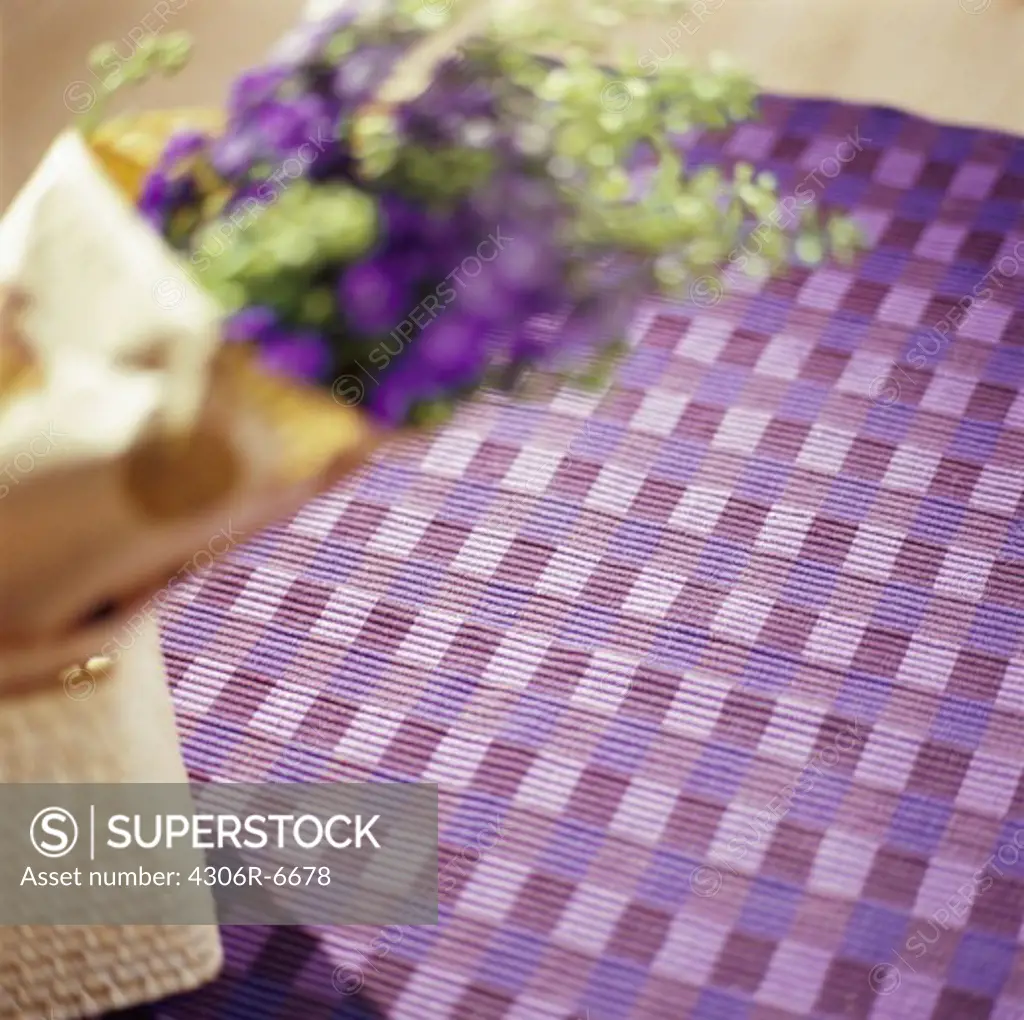 Patterned purple carpet with purple bouquet in foreground