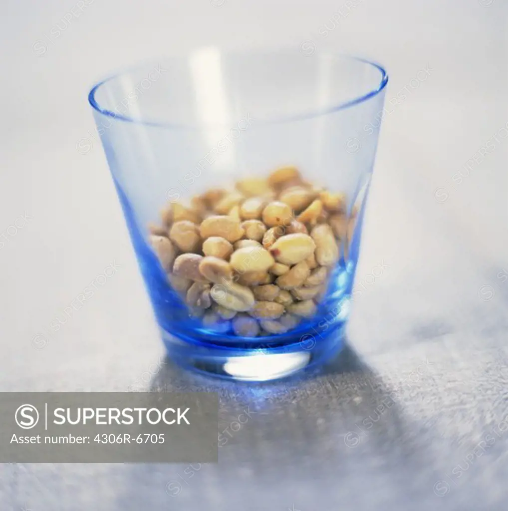 Peanuts in blue glass