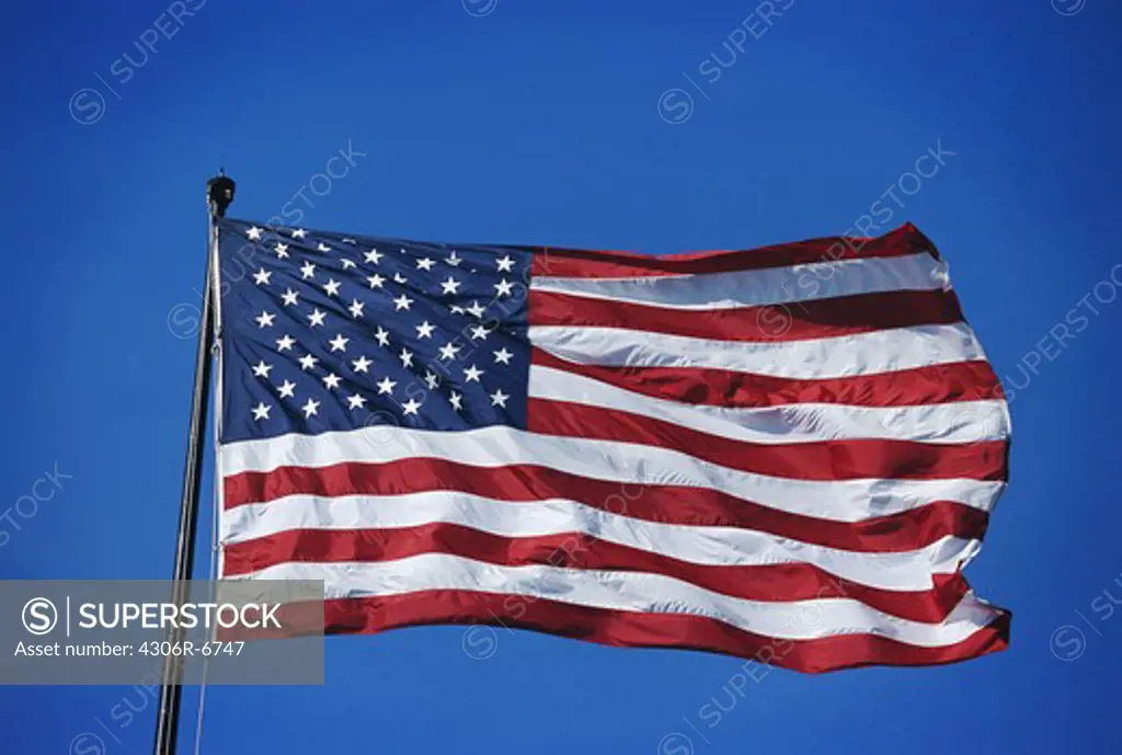 America flag flying against blue sky
