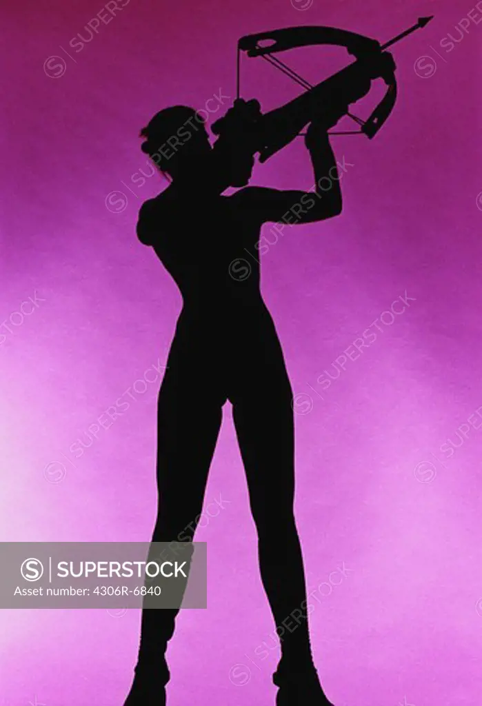 Silhouette of woman aiming with bow and arrow