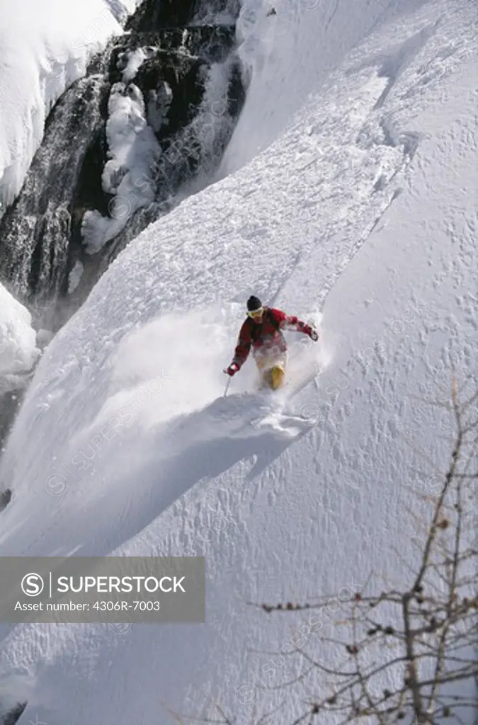 Man downhill skiing in deep powder