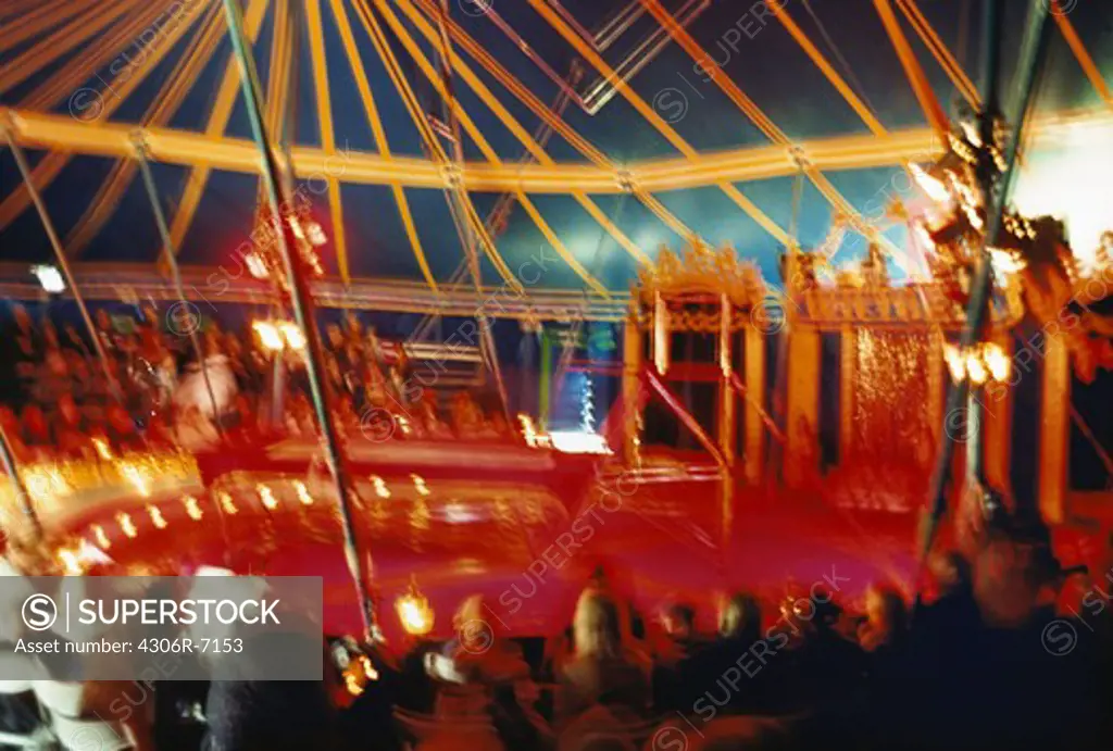 Defocused image of people inside circus tent