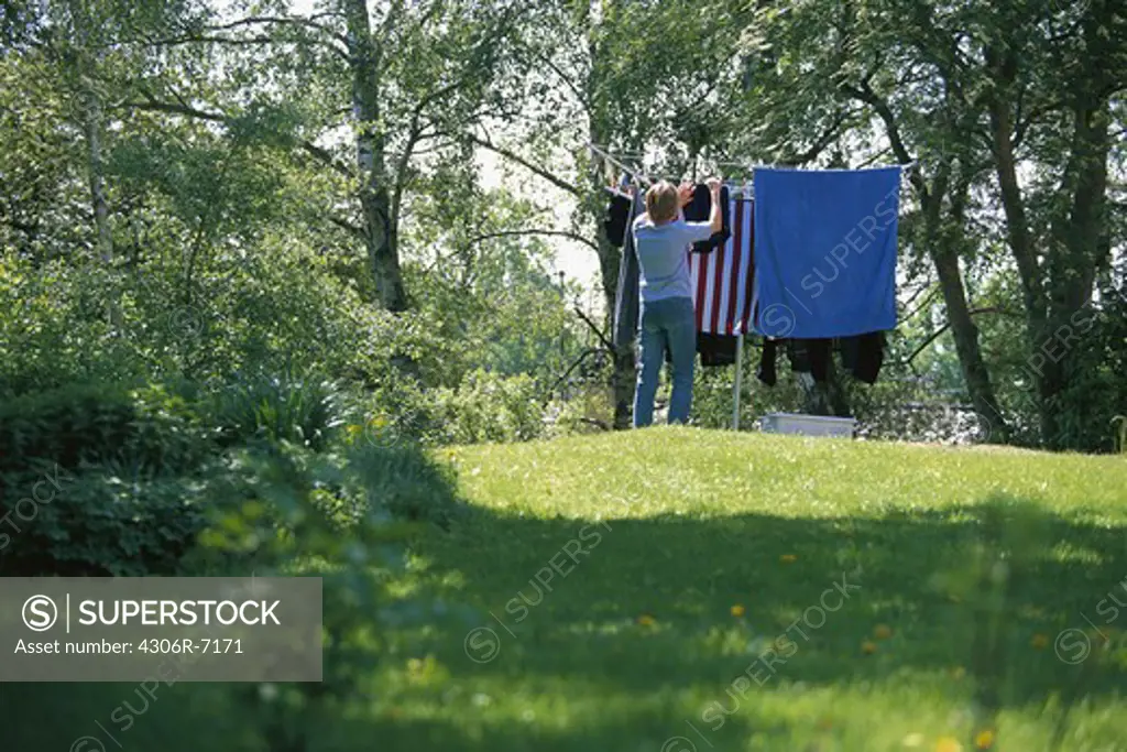 Woman hanging out laundry to dry
