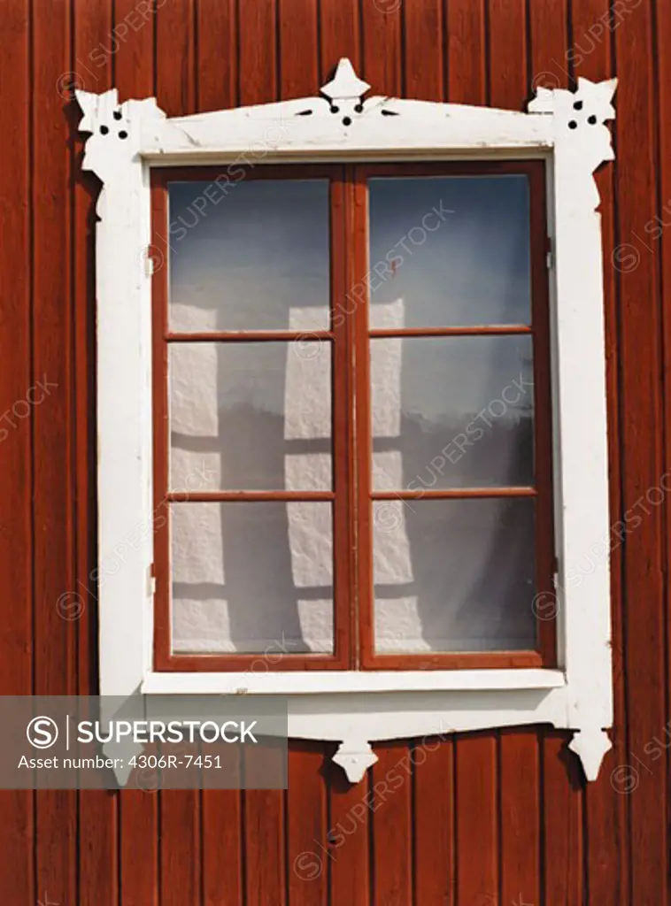 White window frame on red wall of house