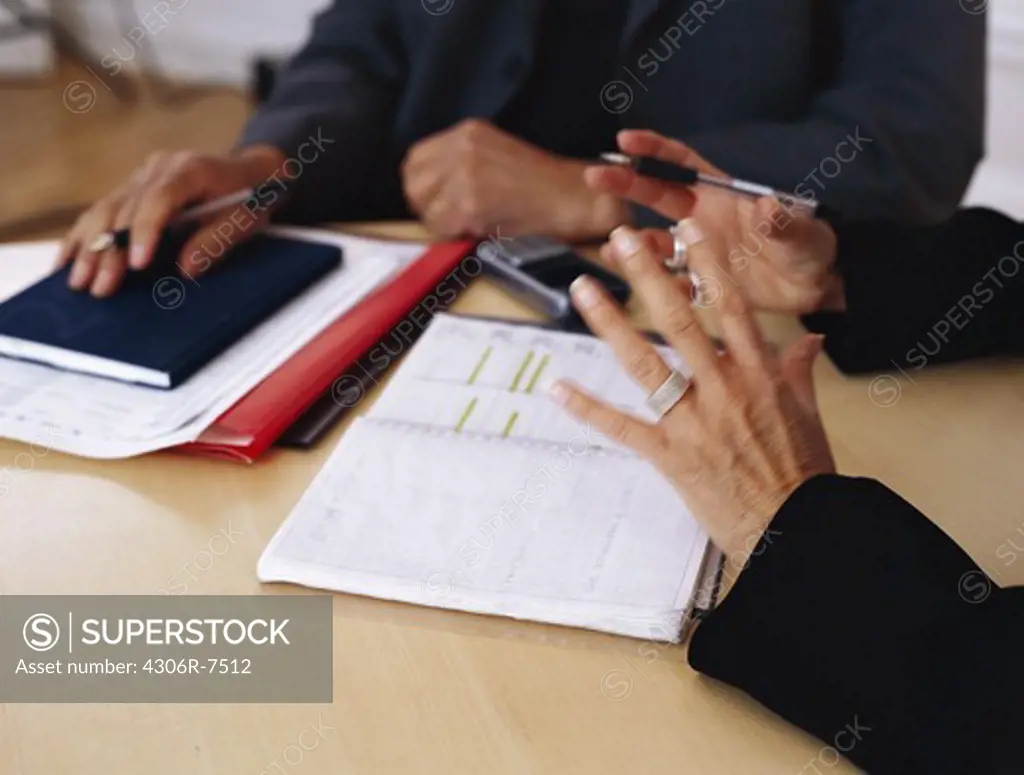 Business people sitting at desk gesturing
