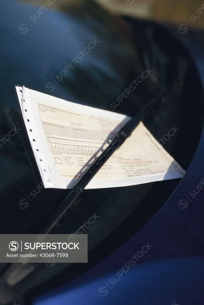 Close-up of ticket on car windscreen