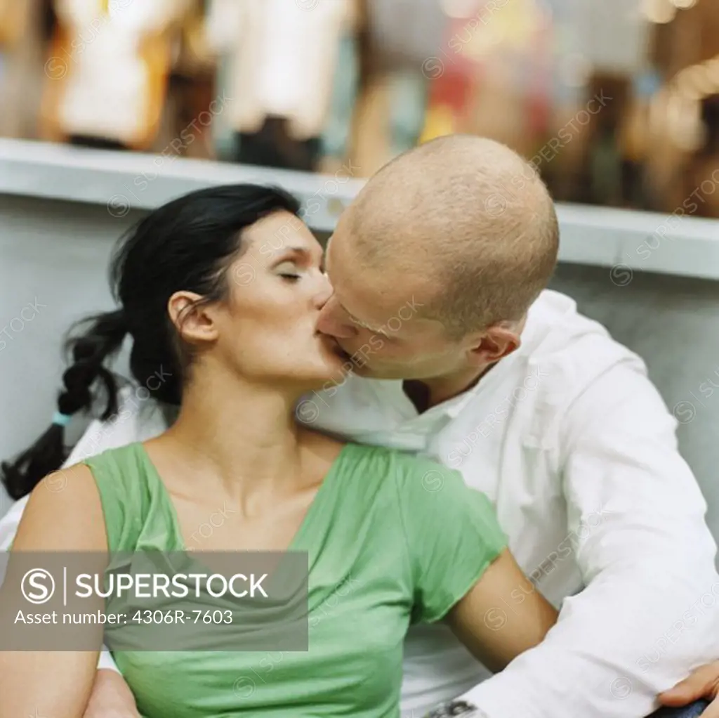 Couple sitting and kissing