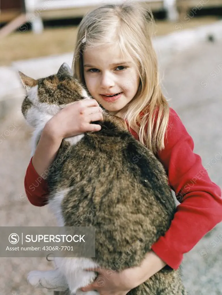 Blonde girl carrying pet cat