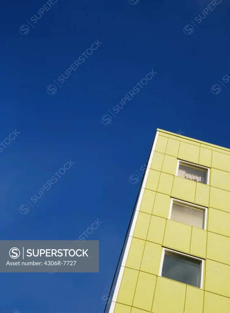 Low angle view of multistorey building against blue sky