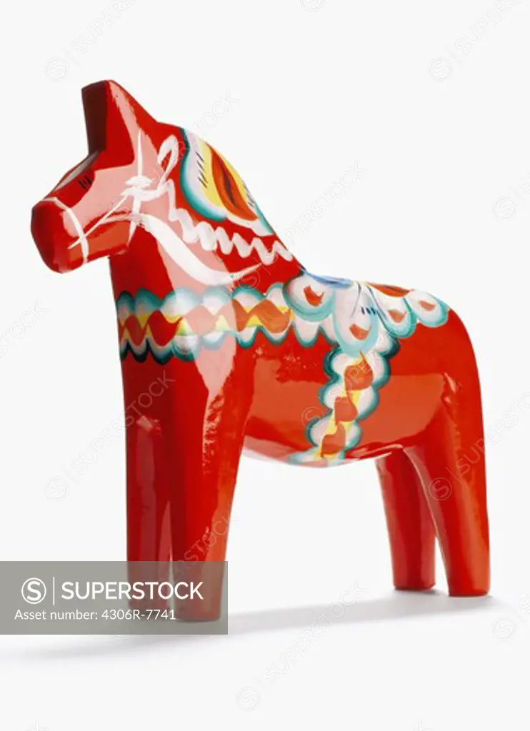 Red dalecarlian horse against white background, close-up