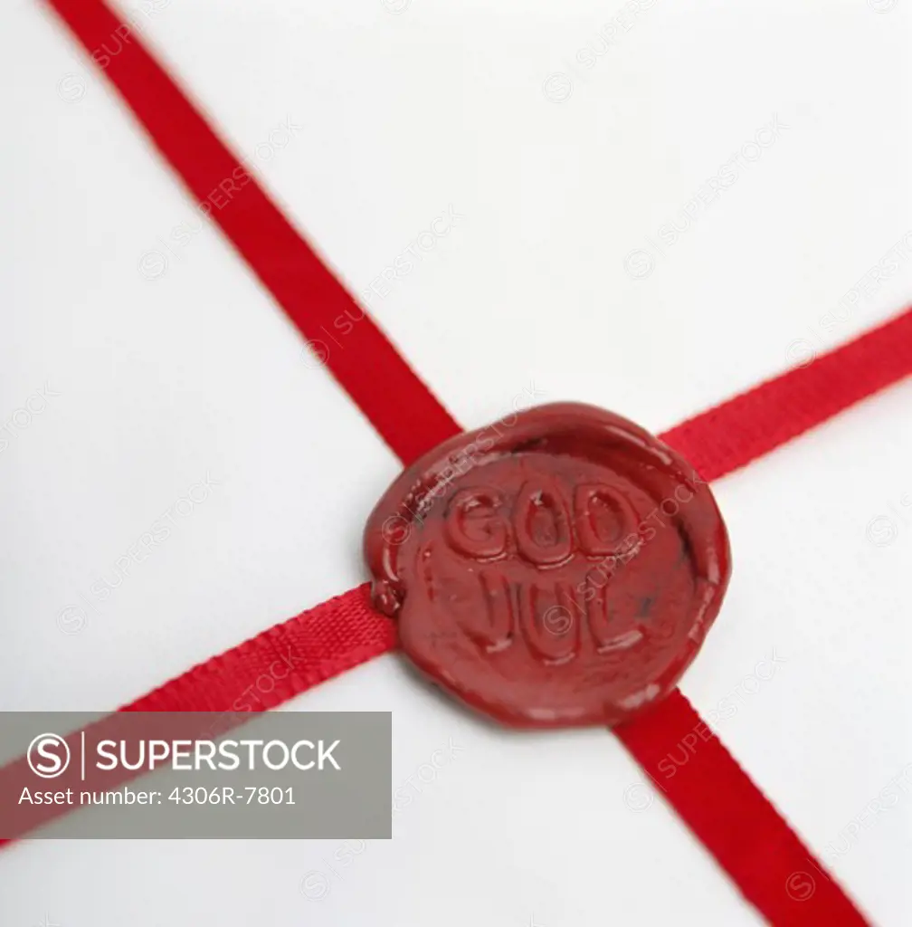 Close-up of red seal on Christmas gift