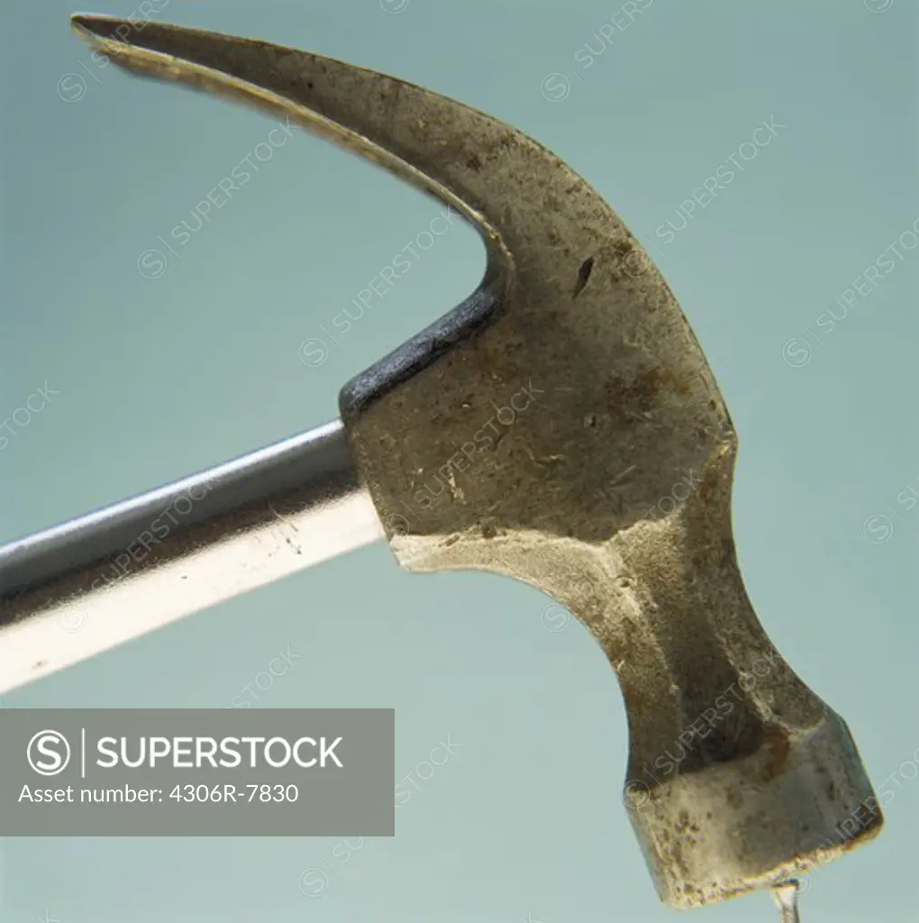 Close-up of hammer against blue background