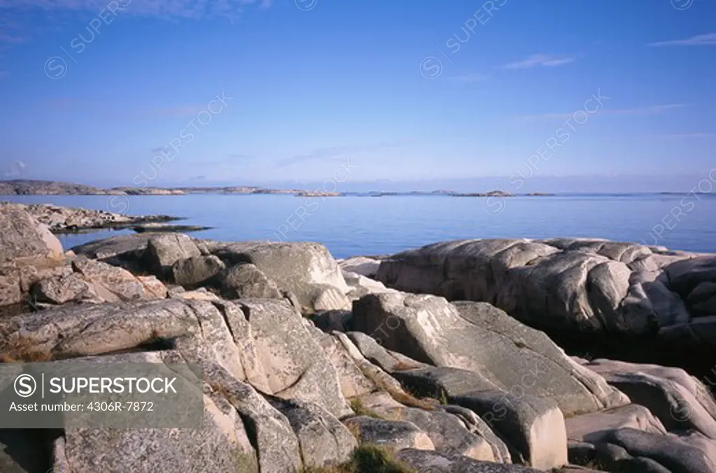 Large rocks with sea and sky in background
