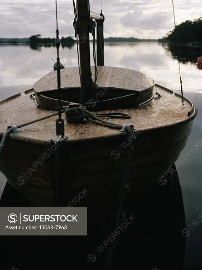 Wooden boat in sea with sky in background