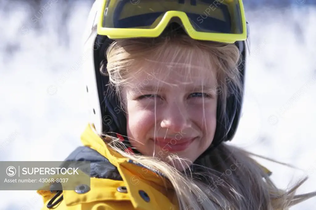 Portrait of girl wearing warm clothing and ski goggles