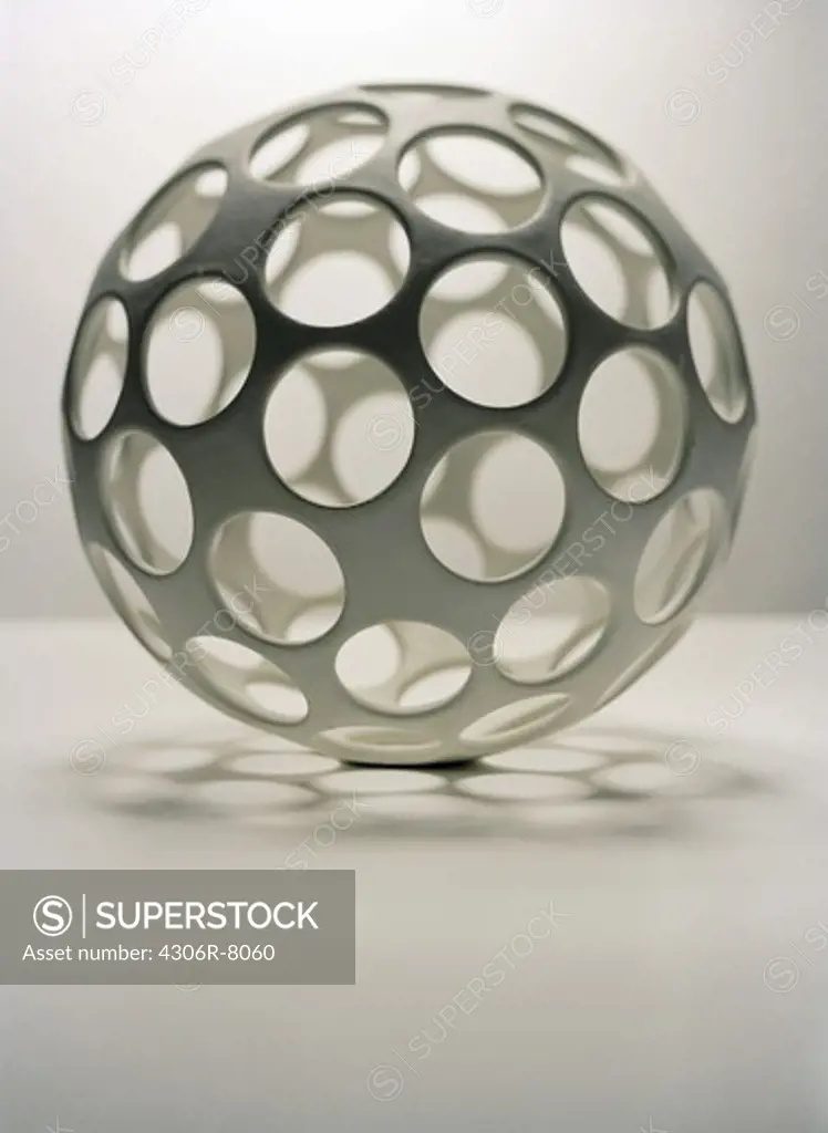 Ball with round holes on white background