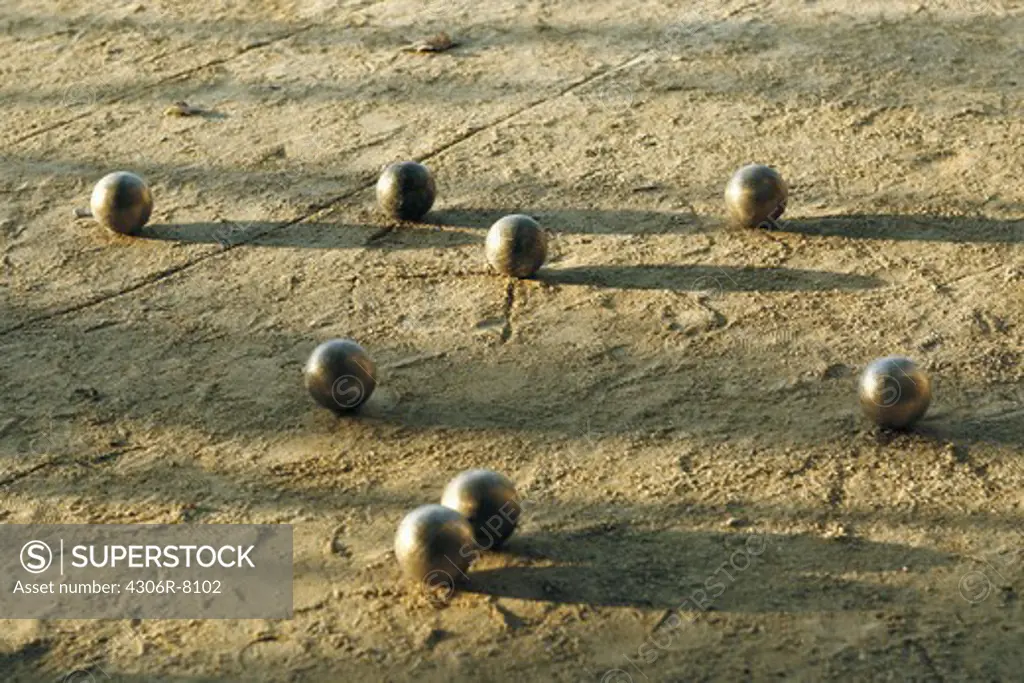 Metal balls scattered in mud