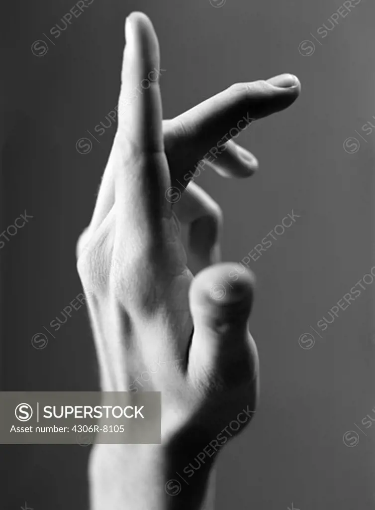 Human hand gesturing against grey background