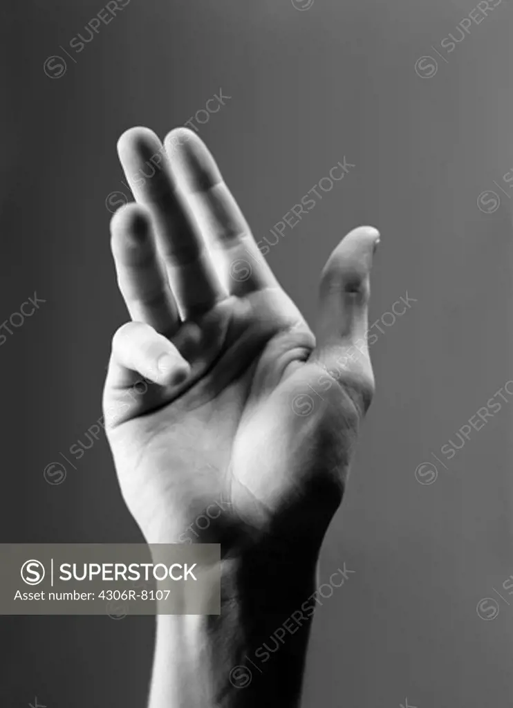 Human hand gesturing against grey background