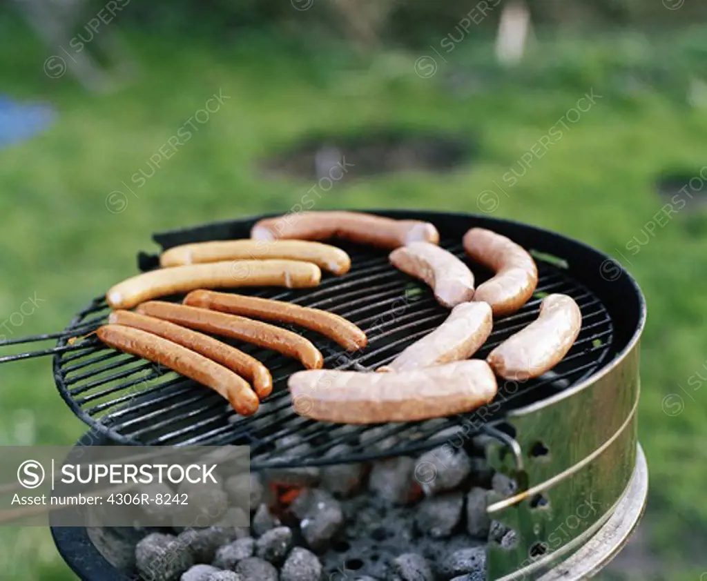 Sausages being grilled on barbeque grill