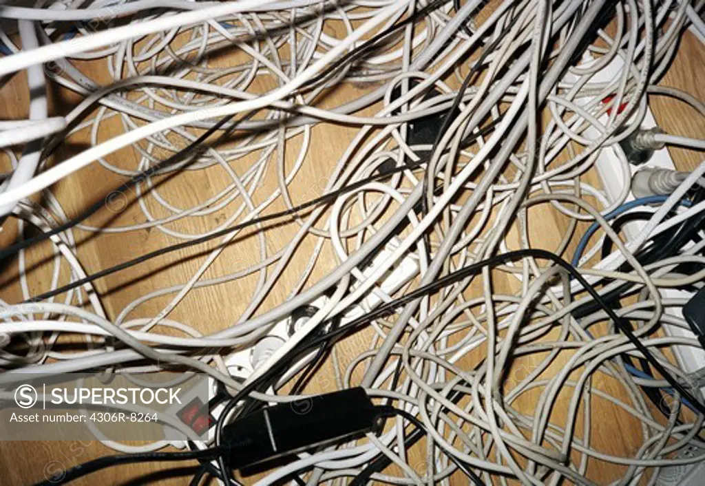 Tangled electric cords on floor, close-up
