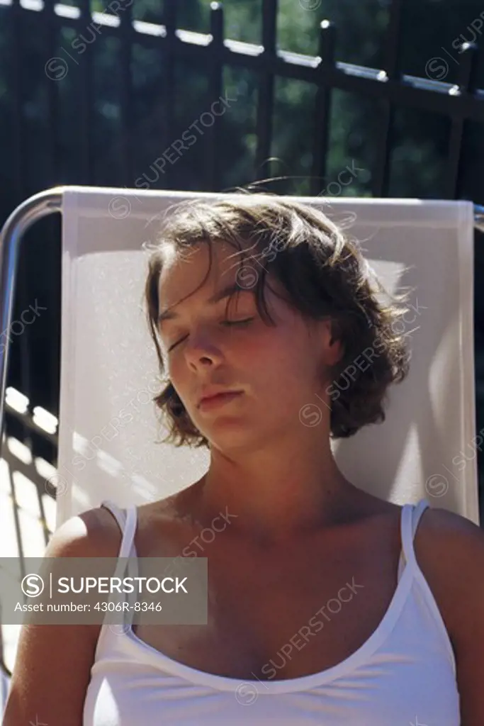 Woman sleeping on sun chair