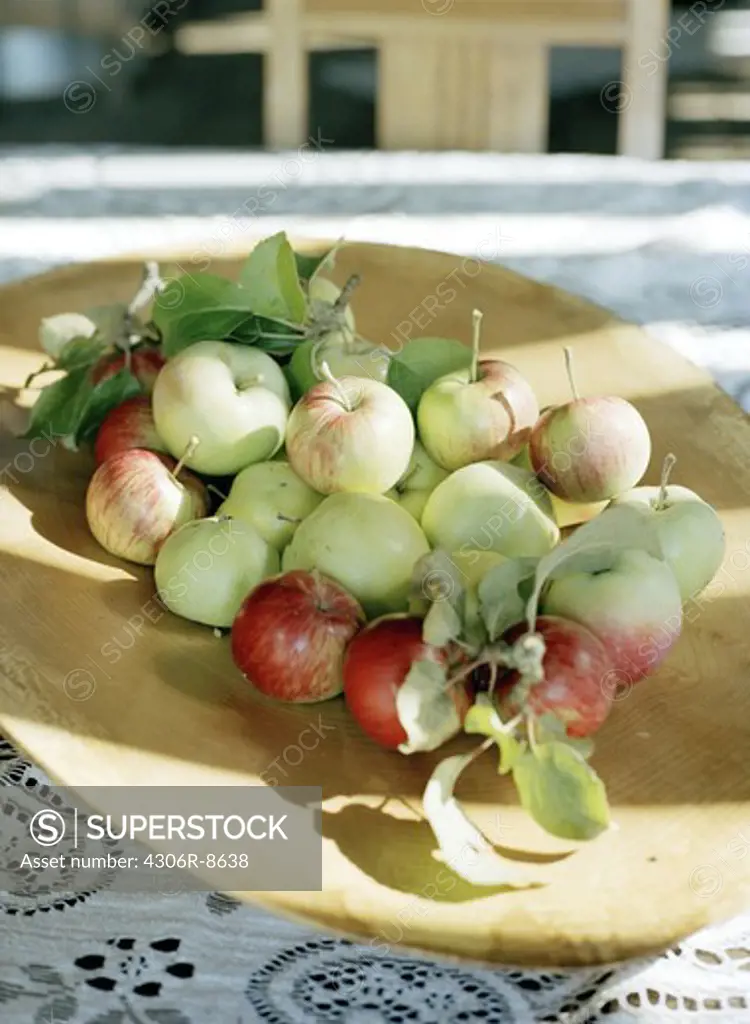 Green and red apples on tray