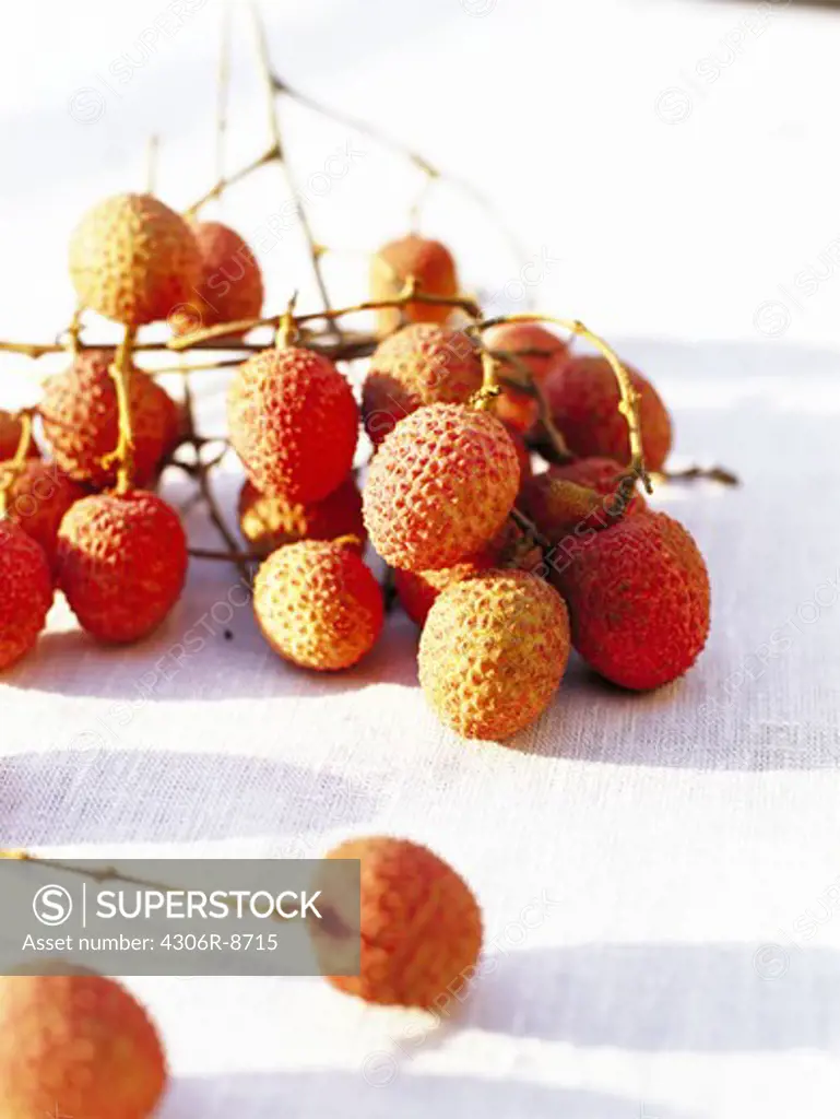 Litchi fruits on a table-cloth, close-up.