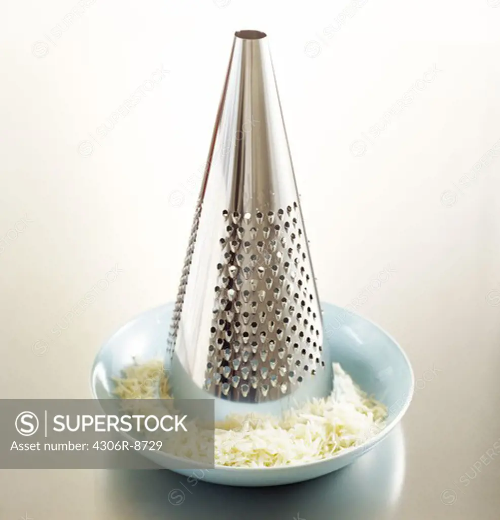 A grater and cheese, close-up.
