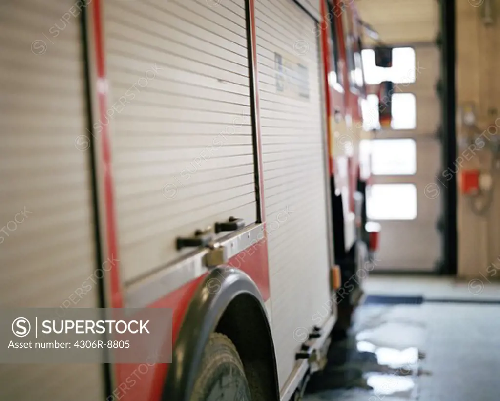 A fire-engine in a garage, close-up.