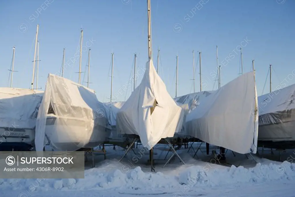 Sailing boats on land in the winter.