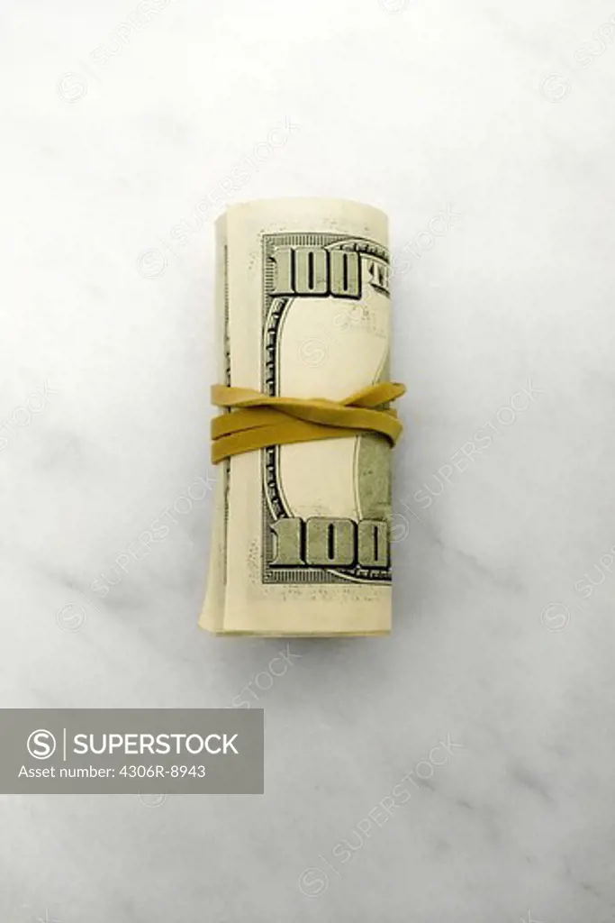 Dollar bills rolled up with a rubberband.