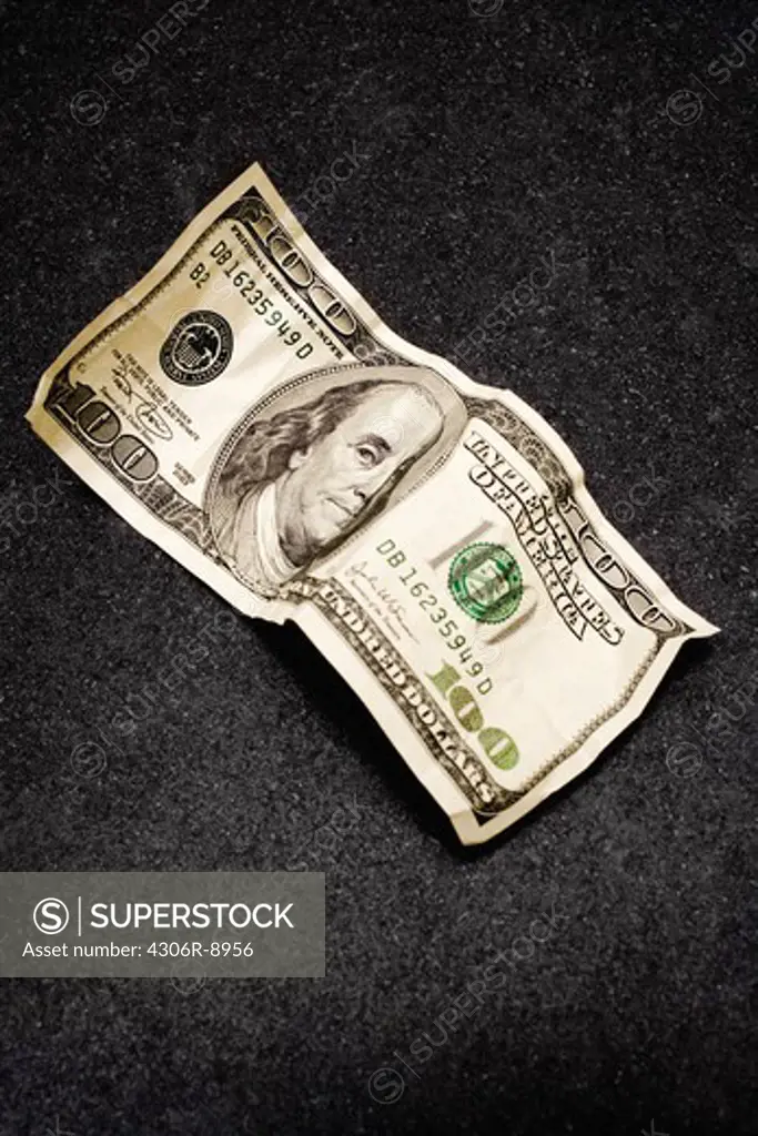 A lumpy dollar bill, close-up.