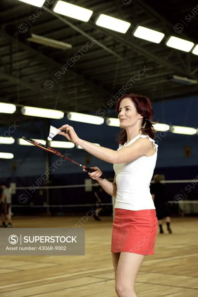 A woman playing badminton.