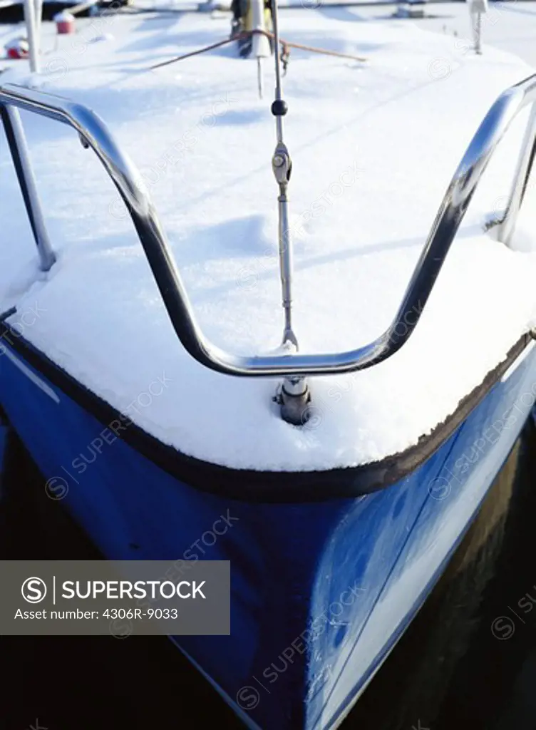 The stern of a sailing boat covered in snow.