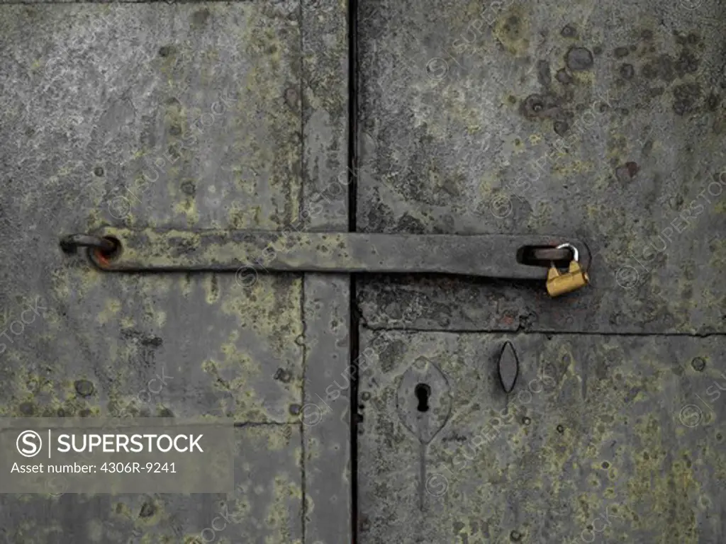 An iron door with a padlock.