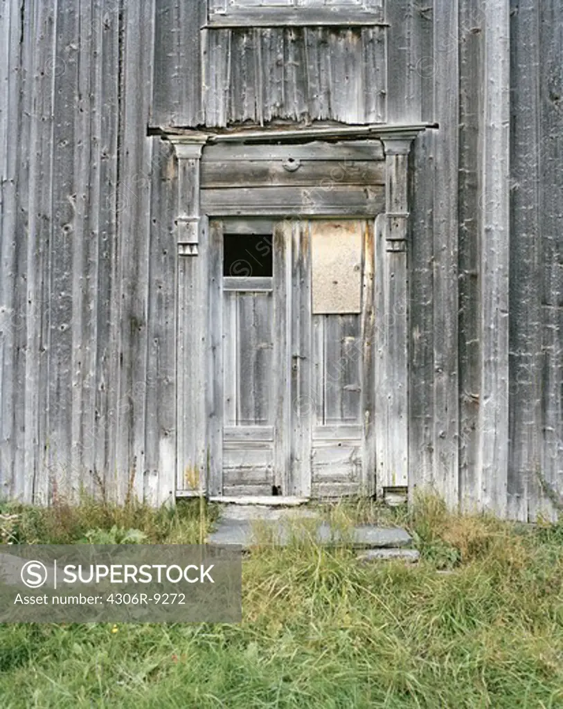 A worn door on a worn house.