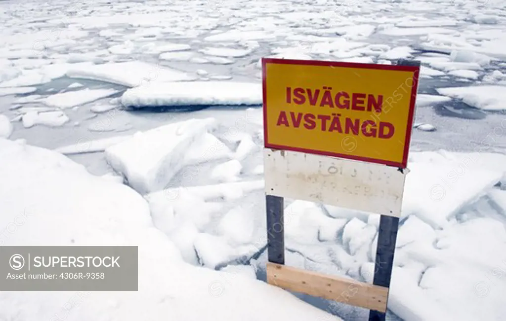 Road sign by a closed ice road.