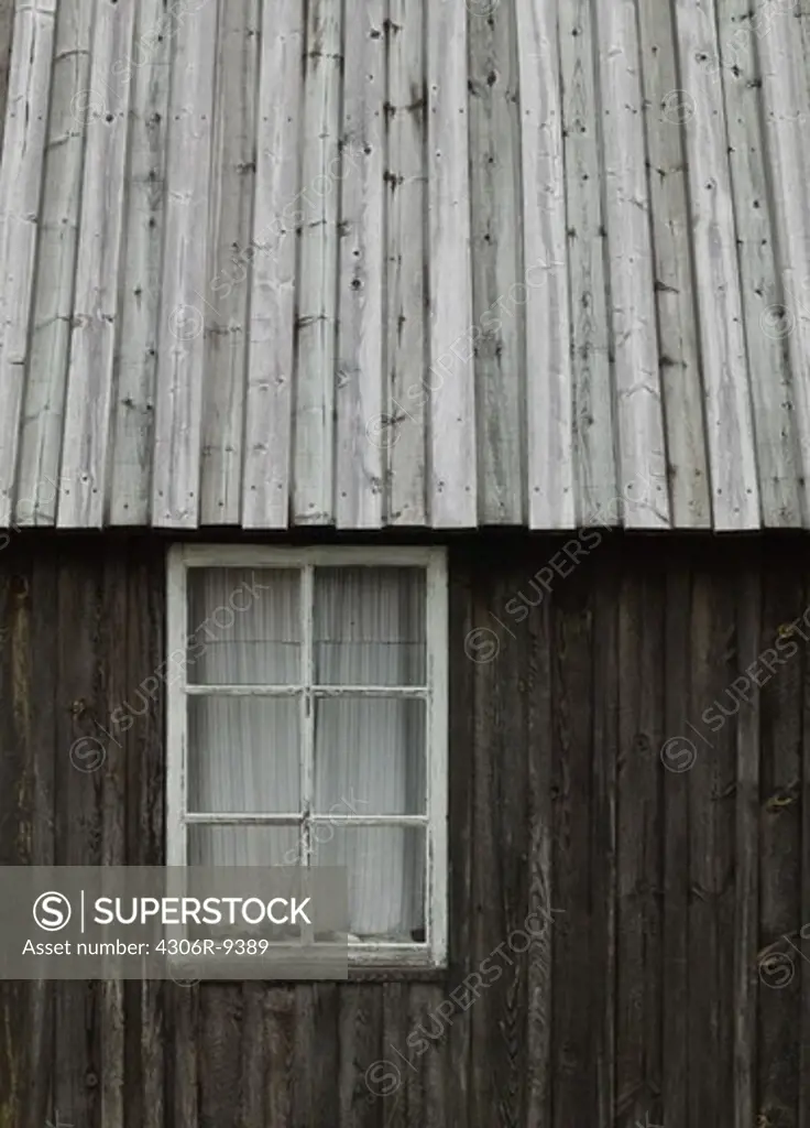A window on a grey barn.