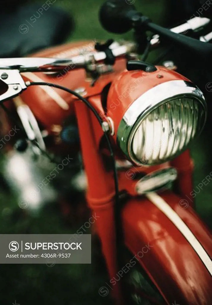 A red Husqvarna moped.