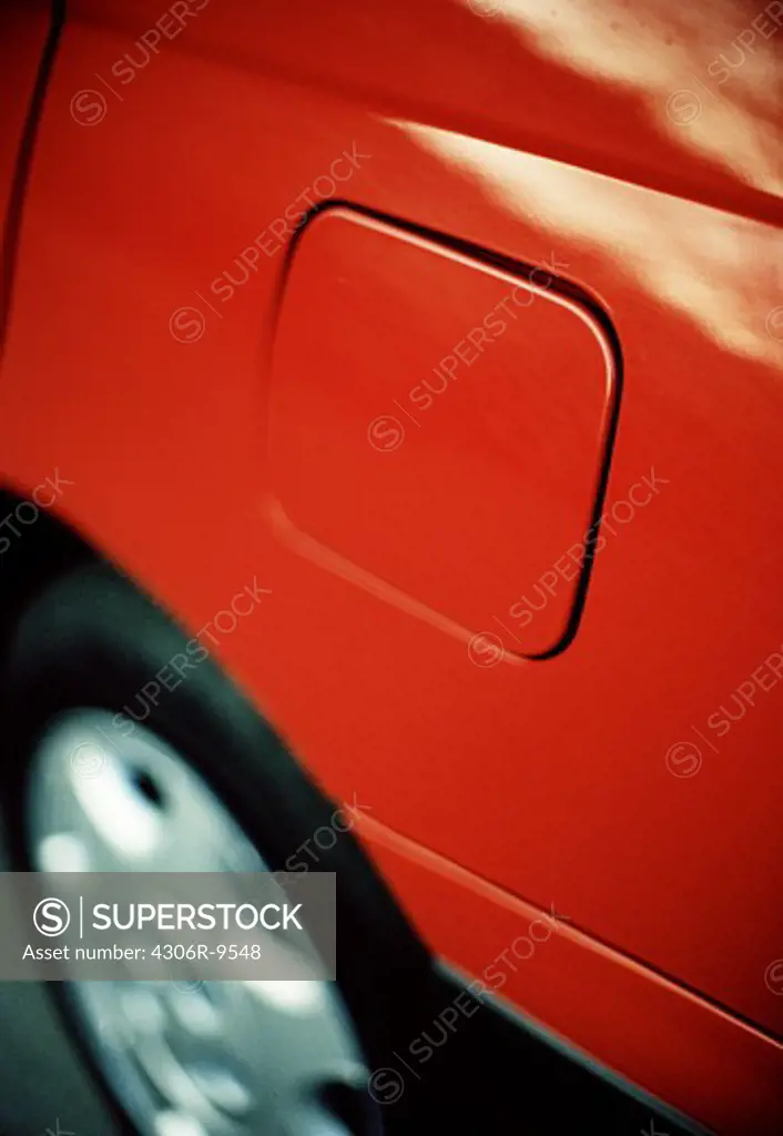 A petrol lid on a red car.