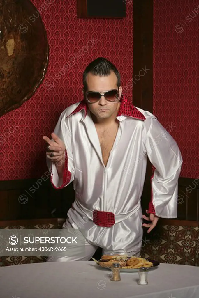 A man dressed up as Elvis.