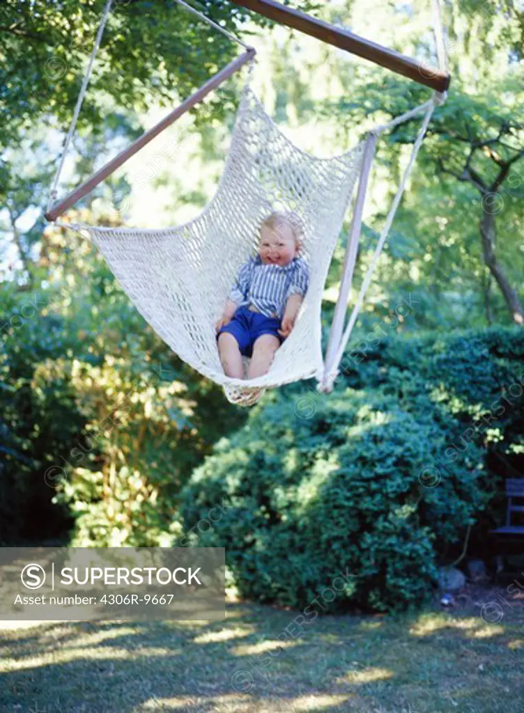 A girl swinging in a hammock.