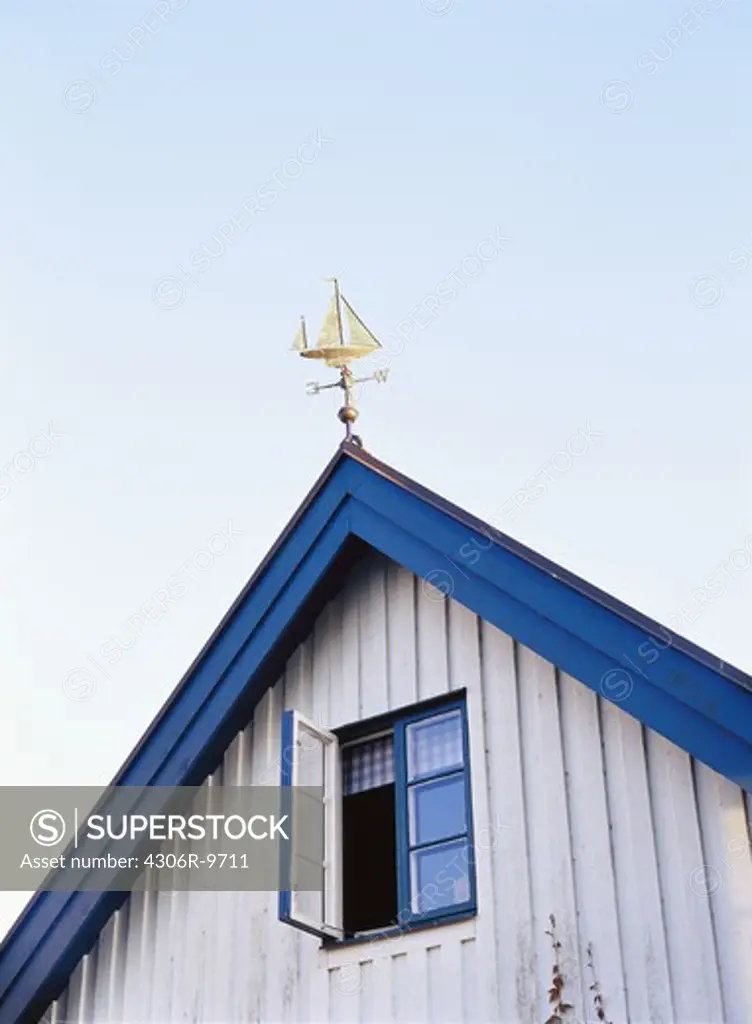 A weather vane on a roof.