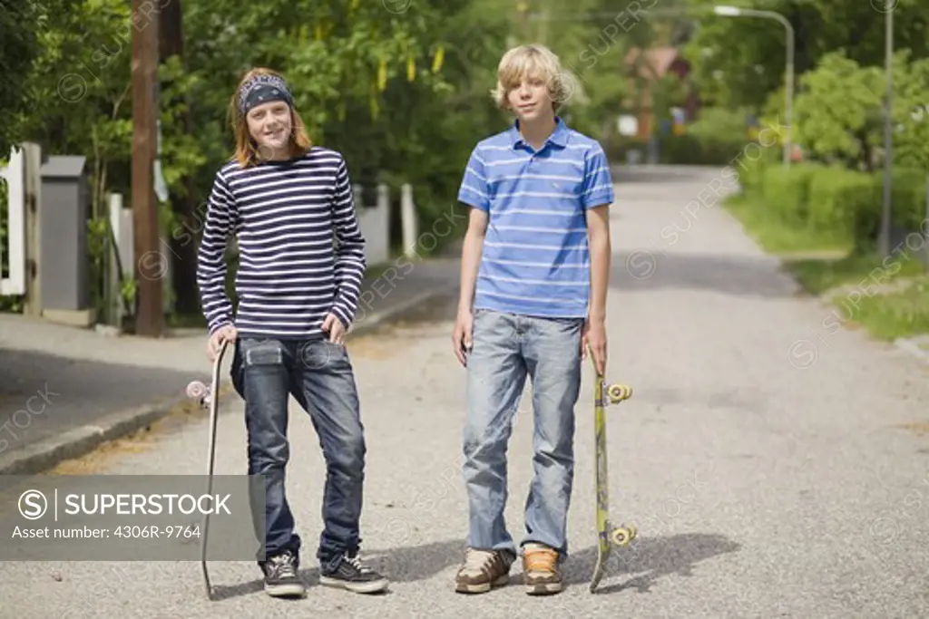 Two boys with skateboards.