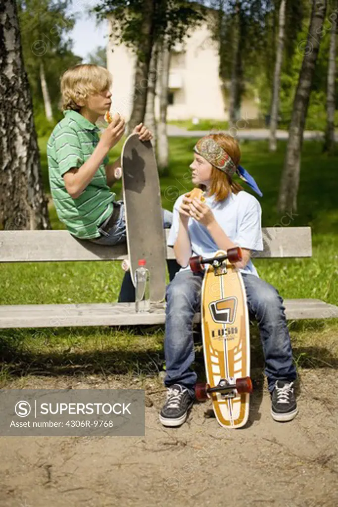 Two teenagers with skateboards.