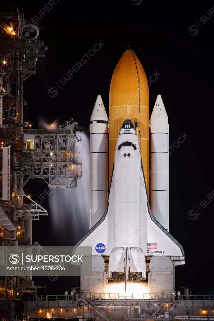 CAPE CANAVERAL, Fla.- Fire forms space shuttle Discovery on Launch Pad 39A at NASA's Kennedy Space Center in Florida as it races toward space on the STS-128 mission. Liftoff from Launch Pad 39A was on time at 11:59 p.m. EDT. The first launch attempt on Aug. 24 was postponed due to unfavorable weather conditions. The second attempt on Aug. 25 also was postponed due to an issue with a valve in space shuttle Discovery's main propulsion system. The STS-128 mission is the 30th International Space Sta