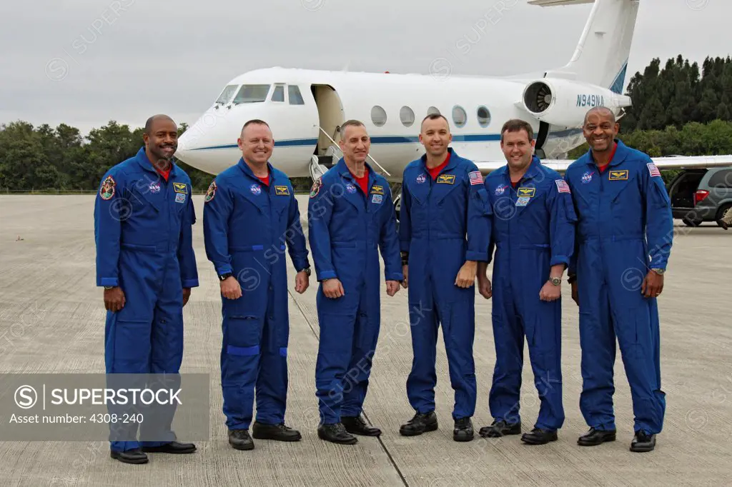 CAPE CANAVERAL, Fla. - The STS-129 crew pauses for a group portrait at the Shuttle Landing Facility at NASA's Kennedy Space Center in Florida. From left are Mission Specialist Leland Melvin; Pilot Barry E. Wilmore; Commander Charles O. Hobaugh; and Mission Specialists Randy Bresnik, Mike Foreman and Robert L. Satcher Jr. The six astronauts for space shuttle Atlantis STS-129 mission arrived at Kennedy aboard a NASA Shuttle Training Aircraft, a modified Gulfstream II jet, to make final preparatio