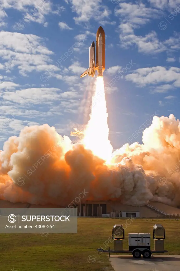 CAPE CANAVERAL, Fla. - With nearly 7 million pounds of thrust generated by twin solid rocket boosters and three main engines, space shuttle Atlantis races to orbit over Launch Pad 39A at NASA's Kennedy Space Center in Florida. Liftoff on its STS-129 mission came at 2:28 p.m. EST Nov. 16. Aboard are crew members Commander Charles O. Hobaugh; Pilot Barry E. Wilmore; and Mission Specialists Leland Melvin, Randy Bresnik, Mike Foreman and Robert L. Satcher Jr. On STS-129, the crew will deliver two Ex